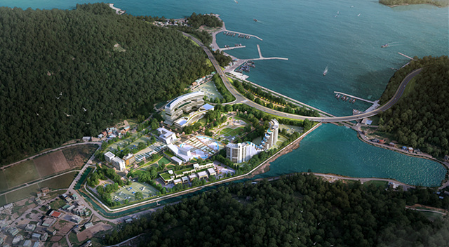 해안가에 위치한 리조트 단지의 조감도. 주변에 녹지와 바다가 펼쳐져 있으며, 여러 건물과 수영장이 보인다.