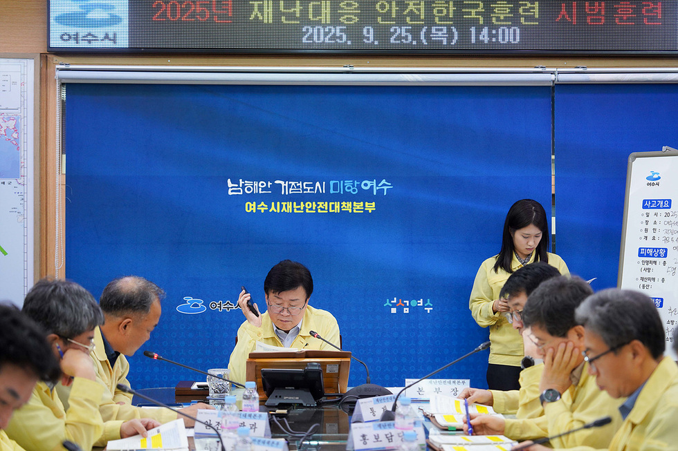 여수시 재난안전대책본부에서 지진과 화재를 가정한 재난 대응 훈련이 진행되고 있으며, 정기명 시장이 회의 중인 모습이다.